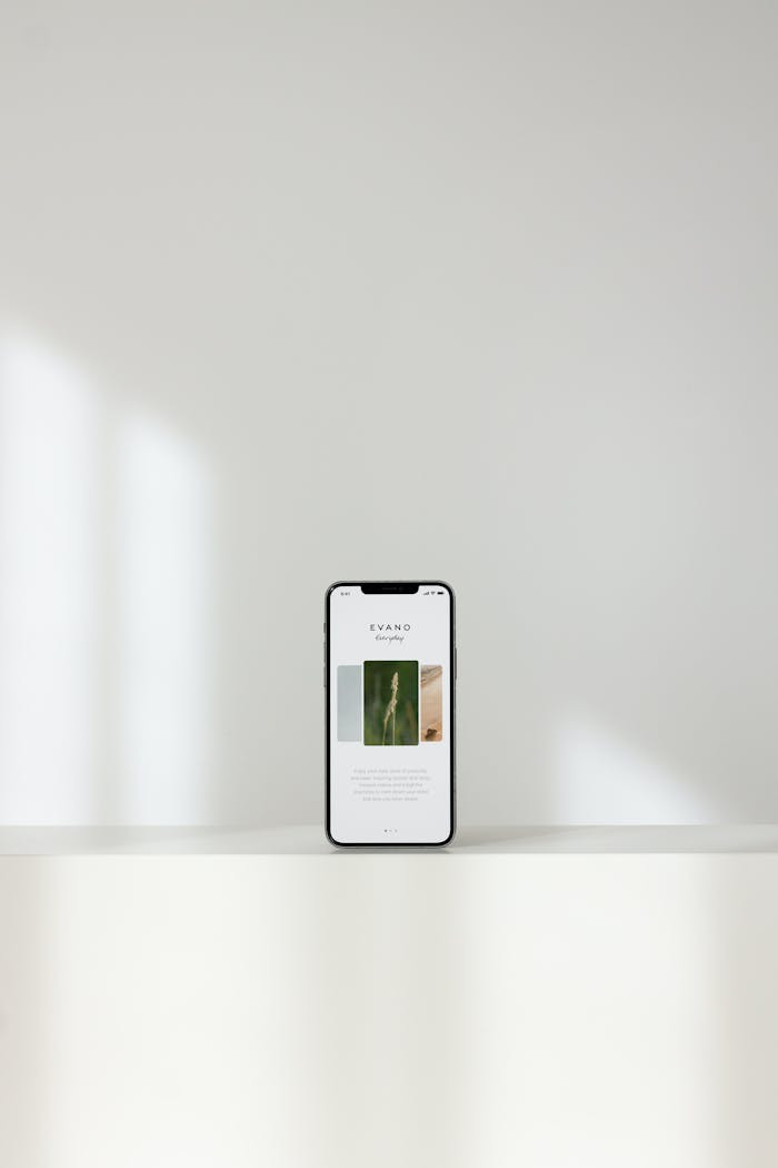 Modern Cellphone on Shelf on White Background